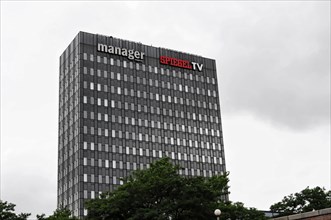 High-rise building labelled Spiegel TV and manager against a cloudy sky, Hamburg, Hanseatic City of