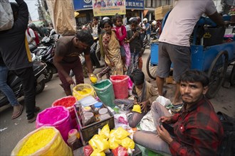 Vendor sells Holi celebration items in a street market, ahead of Holi festival on March 23, 2024 in