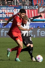Football match, Eren DINKCI 1.FC Heidenheim left in a duel for the ball with Robin HACK Borussia