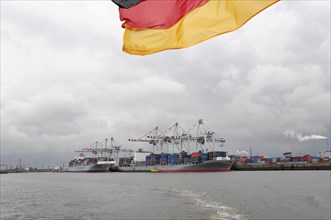 View of a busy container harbour with a waving German flag, Hamburg, Hanseatic City of Hamburg,