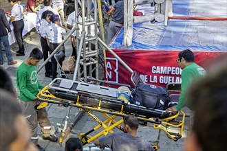 Oaxaca, Mexico, Emergency medical technicians bring in a stretcher and medical equipment in case it