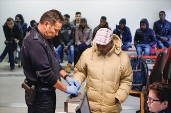 Refugees are registered and recorded by the Federal Police in Rosenheim. A Federal Police officer
