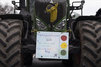 A demonstration sign mounted on a tractor, vehicles block the Strasse des 17. Juni, taken as part