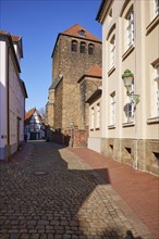 High cobbled street and tower of St Martin's Church in the old town of Minden, Muehlenkreis