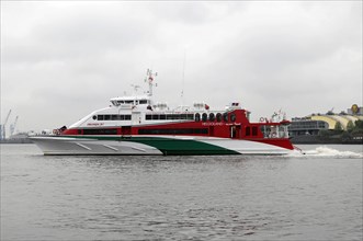 Red and white catamaran on calm waters named 'Halunder Jet', Hamburg, Hanseatic City of Hamburg,