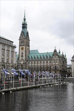 The impressive Hamburg City Hall with tower and flags on the waterfront, Hamburg, Hanseatic City of