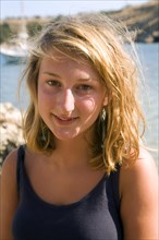 Model released portrait of smiling blonde teenage girl on holiday in the Mediterranean