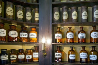 Glass jars with ingredients for medicines stand on a shelf in the historic Berg-Apotheke pharmacy