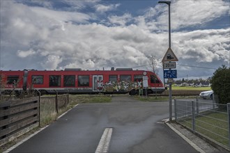 Suburban railway crossing an ungated level crossing in a village, Forth, Middle Franconia, Bavaria,