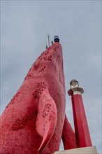 Looking up at a towering red sculpture against a contrasting blue sky, in Ulsan, South Korea, Asia
