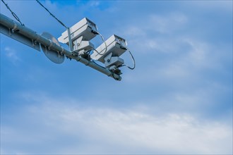 Speed radar cameras mounted on metal pole against blue sky with puffy white clouds in Daejeon,