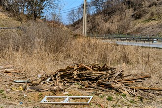 A pile of wooden debris scattered in a rural area showing signs of decay, in South Korea