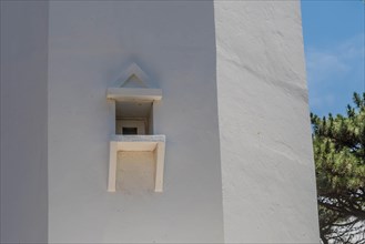 A small decorative window on the white wall of a lighthouse, in Ulsan, South Korea, Asia