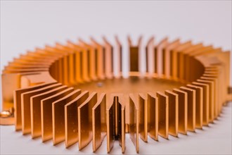 Closeup of round copper computer heat sink fins on white background
