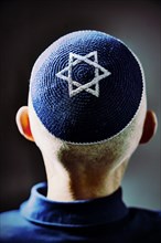 Jewish man wearing a kippa with a Star of David on his head, back view, studio shot, Germany,