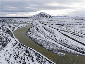 Overgrown river landscape, onset of winter, volcanic hills, Fjallabak Nature Reserve, drone shot,