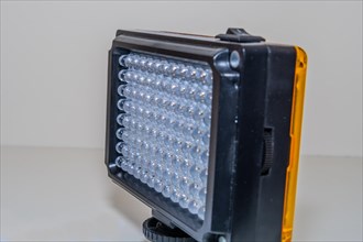 Closeup of LED continuous photographic light on white background. Selective focus on rear row of