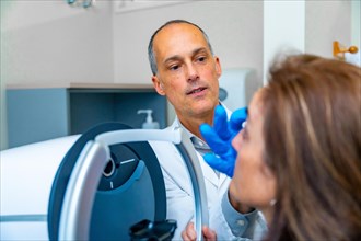 Ophthalmologist checking the eye of a woman during treatment for glaucoma using innovative laser