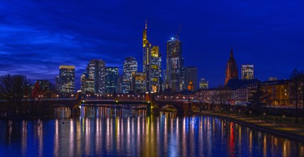 The Frankfurt skyline with office tower blocks behind the Main at blue hour after sunset, on the