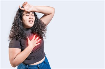 People with heart problems isolated. Latin woman with heart pain on isolated background. Young