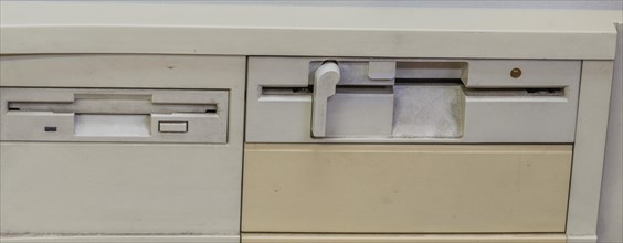 Closeup of obsolete 3.5 inch and 5 inch floppy disk drives installed in old computer in Gangneung,