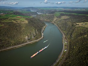 A container ship passes the Middle Rhine near Oberwesel, Rhineland-Palatinate, Germany, Europe