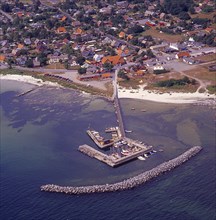 Aerial view of the fishing village Snogebaeck with its harbor out in the sea, southern Bornholm,