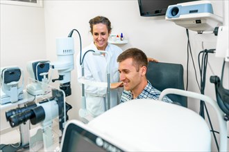 Smiling man on a medical appointment with a female ophthalmologist