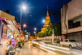 A bustling street scene at night with long exposure of city lights, in Chiang Mai, Thailand, Asia