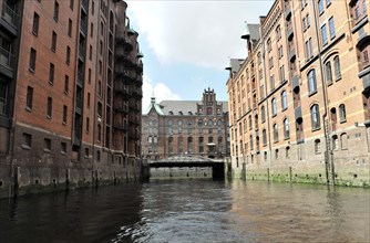 Historic brick buildings on a canal with a bridge in Hamburg's Speicherstadt, Hamburg, Hanseatic