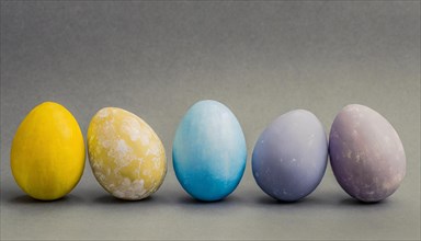 Easter eggs in soft pastel colours lined up next to each other, Easter symbol, AI generated, AI