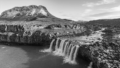Pjofafoss waterfall, Burfell mountain in the background, drone shot, black and white image,
