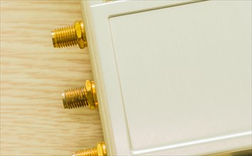 Gold-plated antenna ports on beige technology hardware, in South Korea