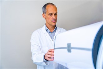 Ophthalmologist preparing an innovative laser machine to treat patients with glaucoma