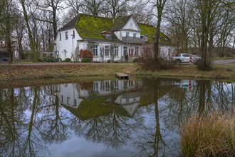 Old manor house reflected in the extinguishing pond, Othenstorf, Mecklenburg-Vorpommern, Germany,