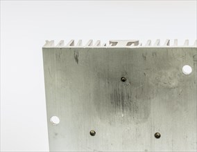 Closeup of mounting surface of rectangle aluminum heat sink on white background
