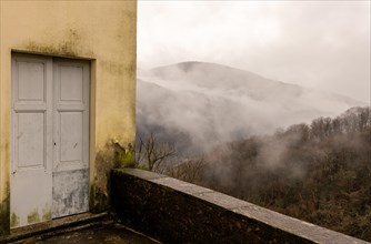 Door with Mountain View in a Rainy Day in Castelrotto, Ticino, Switzerland, Europe