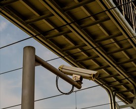 Security camera mounted on a metal pole under a metal bridge in Daejeon, South Korea, Asia