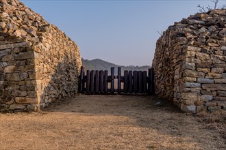 Wooden log blockade at gate of mountain fortress made of flat stones in Boeun, South Korea, Asia