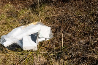 Broken and discarded polystyrene blocks litter a grassy field, in South Korea