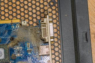 A dusty electronic PC card and connector with visible debris, in South Korea