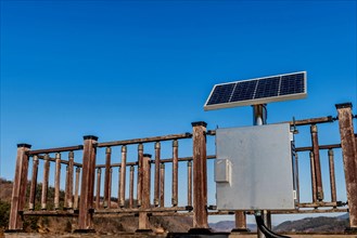 Single small solar panel on pole in front of wooden observation platform in Buan, South Korea, Asia