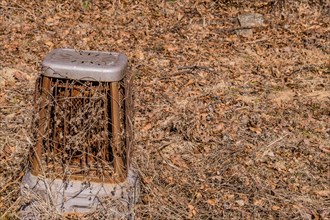 Old rusted metal space heater sitting in open field on dry winter morning in Boeun, South Korea,