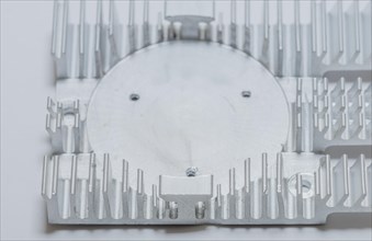 Closeup of fins and fan mounting surface of rectangle aluminum heat sink on white background