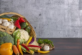 Various fresh vegetables such as peppers, cauliflower, peppers, mushrooms and broccoli in a basket