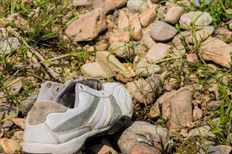 A single abandoned sneaker over a rocky ground, in South Korea