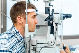 Side view close-up of a men patient having a checkup, eye examined by specialist