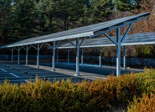A covered parking area equipped with solar panels among trees, in South Korea