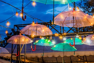 Illuminated umbrellas create a festive atmosphere at twilight, in Chiang Mai, Thailand, Asia