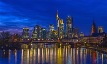 The Frankfurt skyline with office tower blocks behind the Main at blue hour after sunset, on the